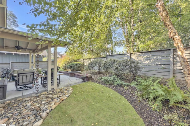 509B Townes St, Greenville, SC 29601 - fenced backyard featuring ceiling fan, a patio area, and a fire pit
