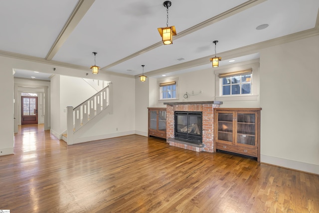 509B Townes St, Greenville, SC 29601 - unfurnished living room featuring stairs, healthy amount of natural light, ornamental molding, wood finished floors, and baseboards