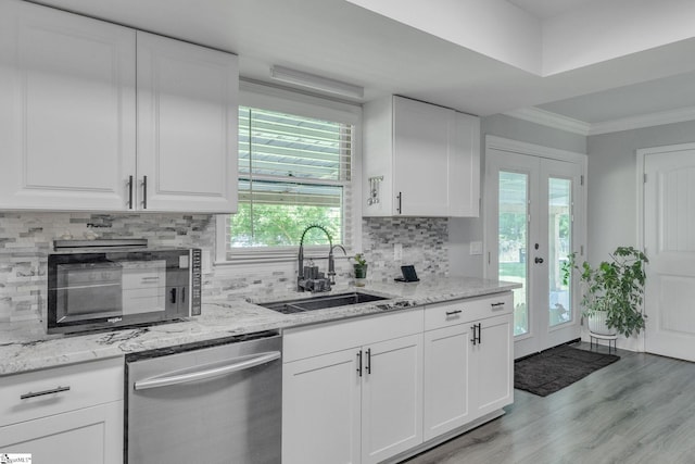 203 Rock Springs Rd, Belton, SC 29627 - kitchen with stainless steel dishwasher, a sink, light wood-style flooring, white cabinetry, and ornamental molding
