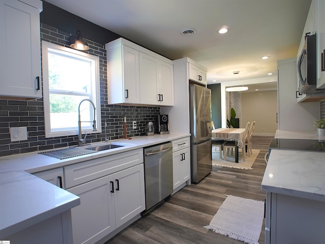 310 Sloping Meadow Dr, Inman, SC 29349 - kitchen with stainless steel appliances, a sink, backsplash, white cabinets, and recessed lighting