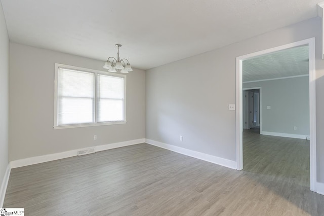112 Summer Dr, Easley, SC 29642 - spare room featuring a chandelier, wood finished floors, and baseboards