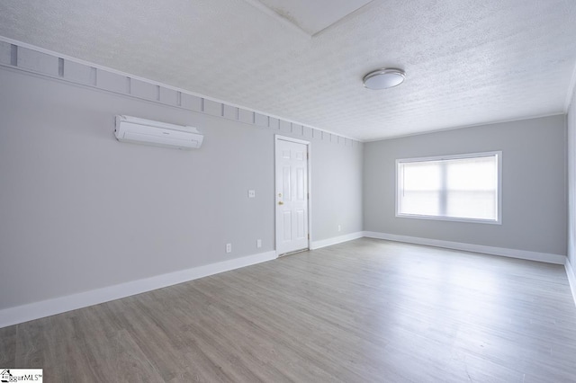 112 Summer Dr, Easley, SC 29642 - spare room with an AC wall unit, wood finished floors, a textured ceiling, and baseboards