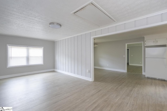 112 Summer Dr, Easley, SC 29642 - empty room with attic access, a textured ceiling, light wood-style floors, and baseboards