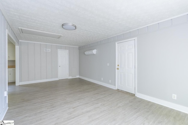112 Summer Dr, Easley, SC 29642 - empty room with a wall unit AC, a textured ceiling, wood finished floors, baseboards, and attic access