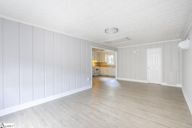 112 Summer Dr, Easley, SC 29642 - unfurnished living room featuring attic access, light wood-style flooring, baseboards, and crown molding