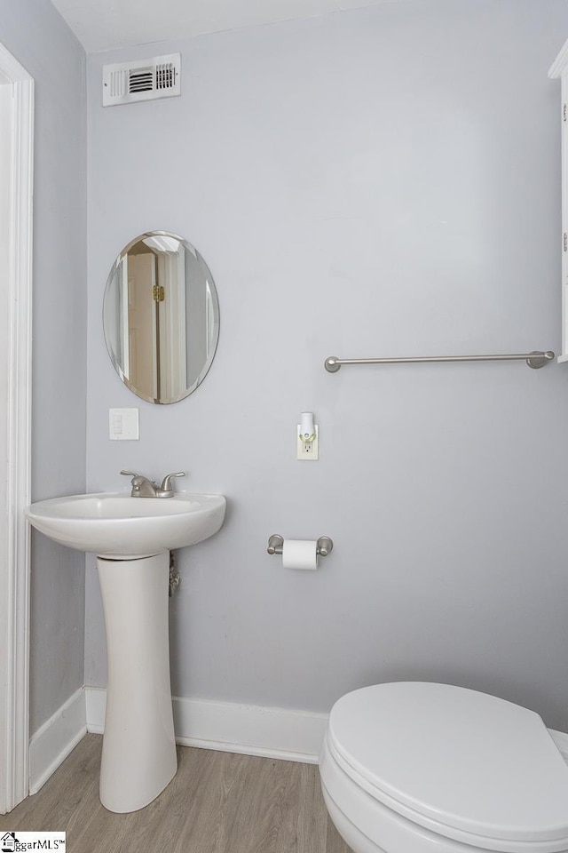 112 Summer Dr, Easley, SC 29642 - half bath with wood finished floors, toilet, baseboards, and a sink