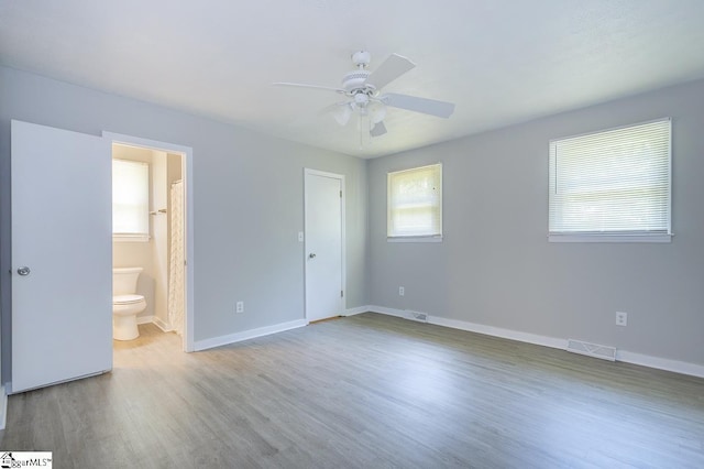 112 Summer Dr, Easley, SC 29642 - unfurnished bedroom with wood finished floors, baseboards, connected bathroom, and a ceiling fan