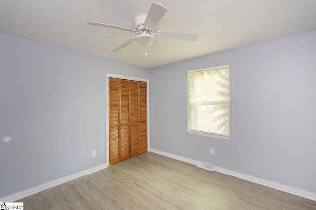 112 Summer Dr, Easley, SC 29642 - unfurnished bedroom with wood finished floors, a closet, baseboards, and a ceiling fan