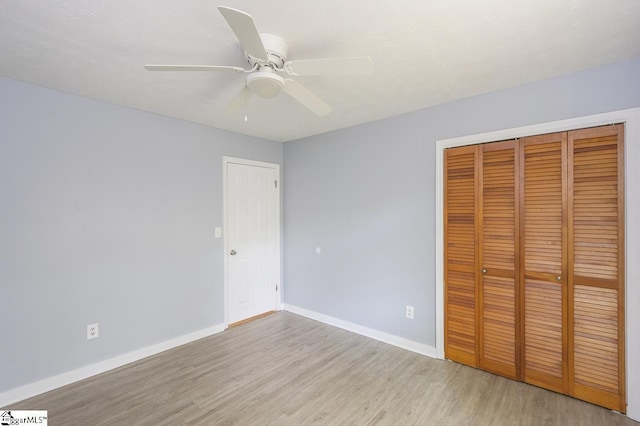 112 Summer Dr, Easley, SC 29642 - unfurnished bedroom featuring wood finished floors, a closet, baseboards, and a ceiling fan