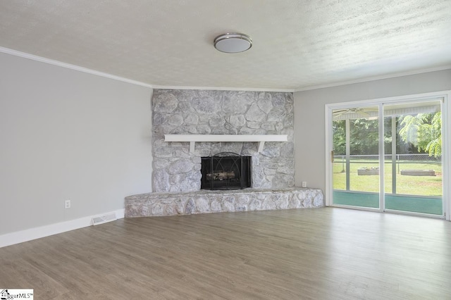 112 Summer Dr, Easley, SC 29642 - unfurnished living room with ornamental molding, a fireplace, wood finished floors, baseboards, and a textured ceiling