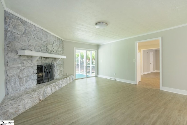 112 Summer Dr, Easley, SC 29642 - unfurnished living room with crown molding, a stone fireplace, wood finished floors, and baseboards