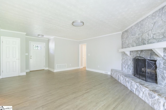 112 Summer Dr, Easley, SC 29642 - unfurnished living room featuring crown molding, wood finished floors, a fireplace, baseboards, and a textured ceiling