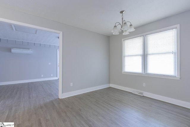 112 Summer Dr, Easley, SC 29642 - unfurnished room with a wall mounted air conditioner, wood finished floors, a chandelier, and baseboards