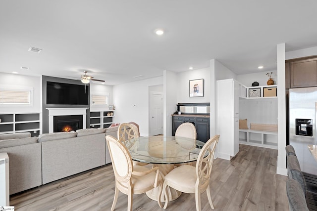 101 Hazelcroft Dr, Fountain Inn, SC 29644 - dining room featuring ceiling fan, light wood-style floors, a lit fireplace, and recessed lighting