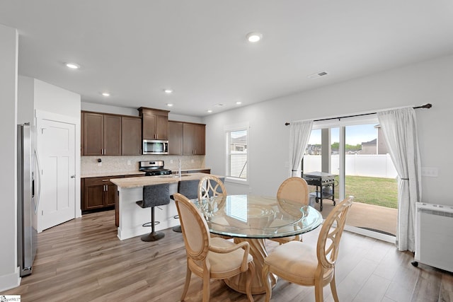101 Hazelcroft Dr, Fountain Inn, SC 29644 - dining room featuring light wood-style flooring, radiator heating unit, recessed lighting, and a water view