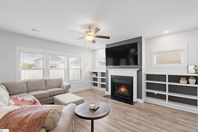 101 Hazelcroft Dr, Fountain Inn, SC 29644 - living room with light wood finished floors, a ceiling fan, baseboards, a fireplace with flush hearth, and recessed lighting