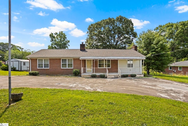 303 Suber Rd, Greer, SC 29651 - ranch-style home with a porch, a front yard, a chimney, and brick siding