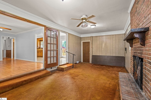 303 Suber Rd, Greer, SC 29651 - unfurnished living room featuring a ceiling fan, ornamental molding, a brick fireplace, carpet floors, and baseboards