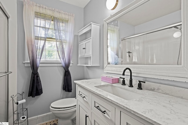 303 Suber Rd, Greer, SC 29651 - full bathroom with a shower with door, toilet, vanity, and baseboards