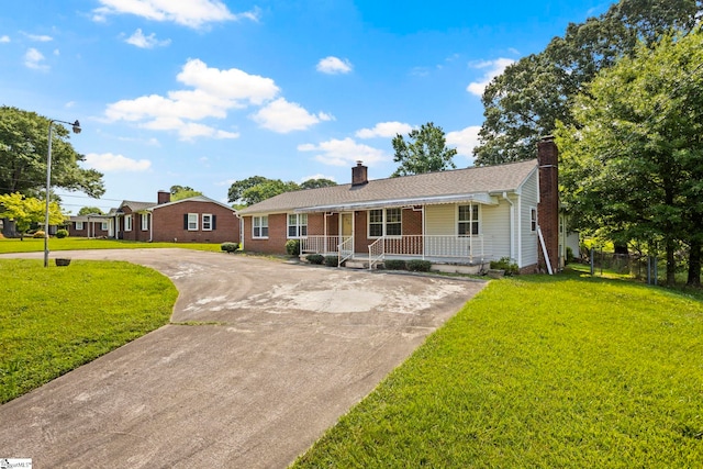 303 Suber Rd, Greer, SC 29651 - ranch-style home with a porch, a chimney, curved driveway, and brick siding