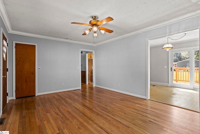 303 Suber Rd, Greer, SC 29651 - spare room featuring a ceiling fan, wood finished floors, crown molding, a textured ceiling, and baseboards
