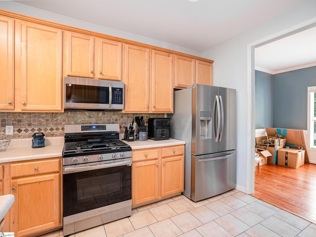 6 Baneberry Ct, Simpsonville, SC 29680 - kitchen featuring appliances with stainless steel finishes, light countertops, backsplash, crown molding, and light brown cabinetry