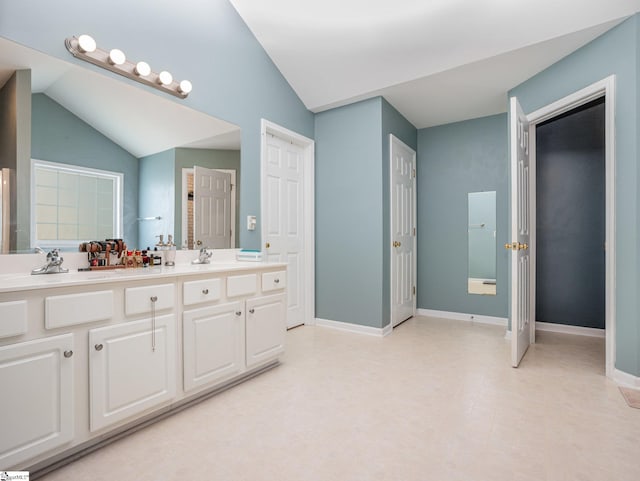 6 Baneberry Ct, Simpsonville, SC 29680 - bathroom featuring double vanity, vaulted ceiling, and baseboards