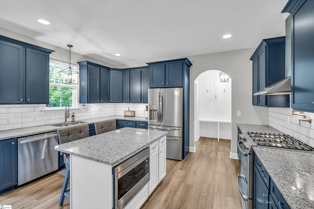 118 Perry Hill Rd, Easley, SC 29640 - kitchen with appliances with stainless steel finishes, a sink, blue cabinets, exhaust hood, and recessed lighting
