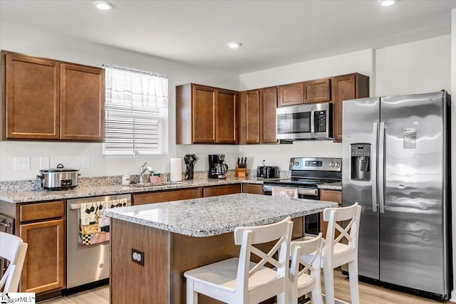 104 Timothy Pl, Easley, SC 29642 - kitchen featuring stainless steel appliances, a sink, light wood-type flooring, light stone countertops, and recessed lighting