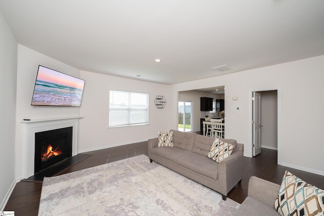 912 Brynderwen Pl, Lyman, SC 29365 - living room featuring a warm lit fireplace, baseboards, dark wood finished floors, and recessed lighting