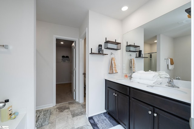 912 Brynderwen Pl, Lyman, SC 29365 - full bathroom with double vanity, a spacious closet, a shower, and baseboards