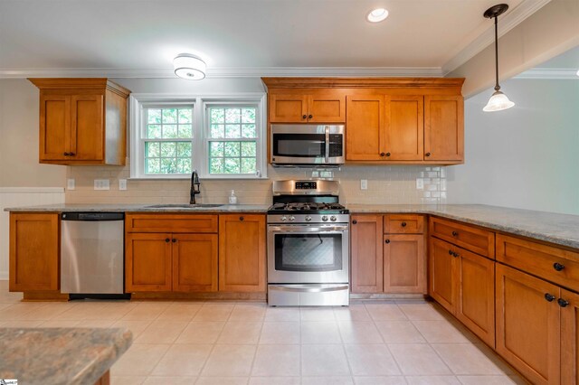 236 S Park Dr, Spartanburg, SC 29302 - kitchen with appliances with stainless steel finishes, a sink, ornamental molding, brown cabinets, and light stone countertops
