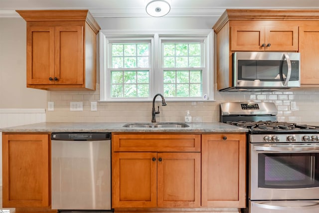 236 S Park Dr, Spartanburg, SC 29302 - kitchen with appliances with stainless steel finishes, a sink, ornamental molding, tasteful backsplash, and brown cabinets