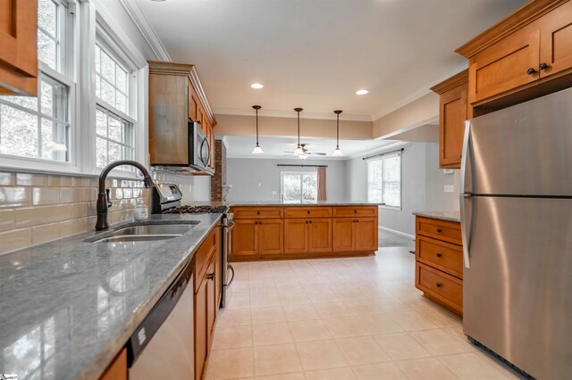 236 S Park Dr, Spartanburg, SC 29302 - kitchen with stainless steel appliances, a sink, brown cabinets, ornamental molding, and recessed lighting