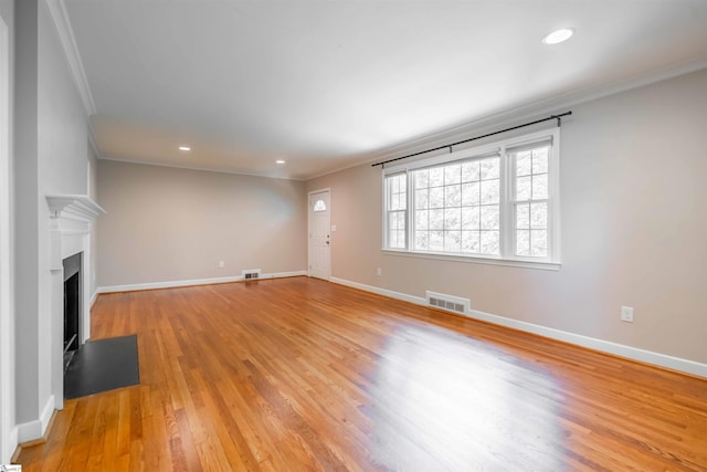 236 S Park Dr, Spartanburg, SC 29302 - unfurnished living room featuring crown molding, light wood-style floors, baseboards, a fireplace with flush hearth, and recessed lighting