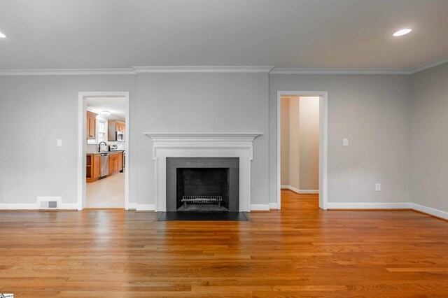 236 S Park Dr, Spartanburg, SC 29302 - unfurnished living room featuring crown molding, light wood finished floors, baseboards, recessed lighting, and a fireplace with flush hearth