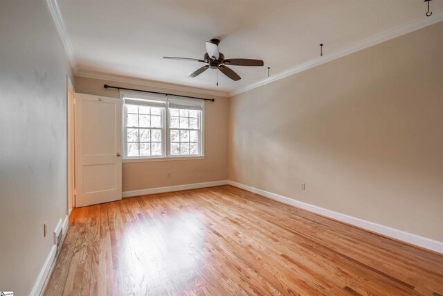 236 S Park Dr, Spartanburg, SC 29302 - empty room with crown molding, light wood-type flooring, a ceiling fan, and baseboards