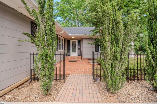 236 S Park Dr, Spartanburg, SC 29302 - view of exterior entry with a gate and roof with shingles