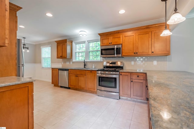236 S Park Dr, Spartanburg, SC 29302 - kitchen featuring stainless steel appliances, ornamental molding, brown cabinets, a sink, and tasteful backsplash