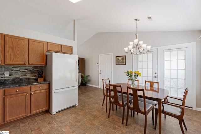 410 Garden Gate Ct, Duncan, SC 29334 - dining space featuring vaulted ceiling, a chandelier, and baseboards