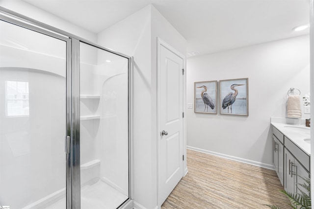116 Southridge Ct, Easley, SC 29642 - bathroom featuring a stall shower, double vanity, baseboards, and wood finished floors