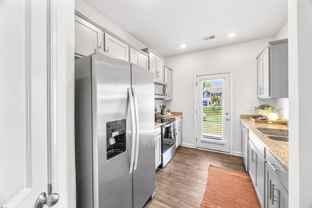 116 Southridge Ct, Easley, SC 29642 - kitchen with appliances with stainless steel finishes, gray cabinets, dark wood-style flooring, light stone counters, and recessed lighting
