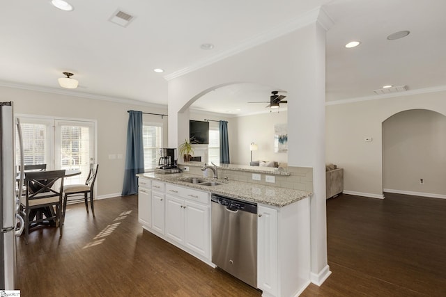 352 Avendell Dr, Easley, SC 29642 - kitchen featuring stainless steel appliances, arched walkways, a sink, light stone counters, and dark wood finished floors