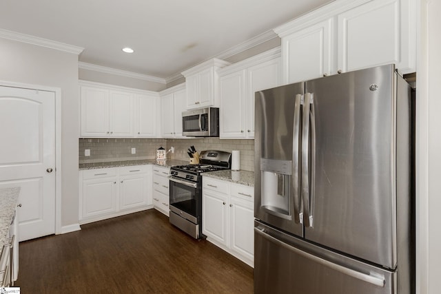 352 Avendell Dr, Easley, SC 29642 - kitchen featuring appliances with stainless steel finishes, dark wood-type flooring, ornamental molding, white cabinetry, and light stone counters