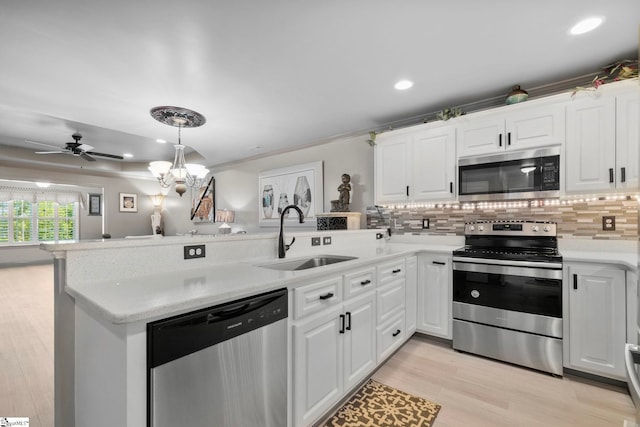 30 Eaglecrest Ct, Simpsonville, SC 29681 - kitchen featuring stainless steel appliances, a sink, a peninsula, backsplash, and white cabinets