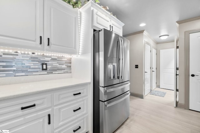 30 Eaglecrest Ct, Simpsonville, SC 29681 - kitchen featuring stainless steel fridge with ice dispenser, decorative backsplash, white cabinets, baseboards, and light wood-type flooring