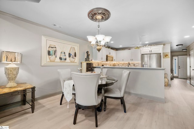 30 Eaglecrest Ct, Simpsonville, SC 29681 - dining area with a chandelier, light wood-style flooring, ornamental molding, recessed lighting, and baseboards
