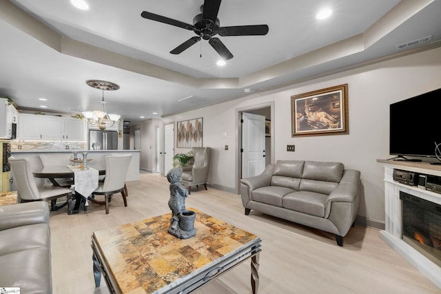 30 Eaglecrest Ct, Simpsonville, SC 29681 - living area featuring light wood-style floors, recessed lighting, a chandelier, a ceiling fan, and a raised ceiling