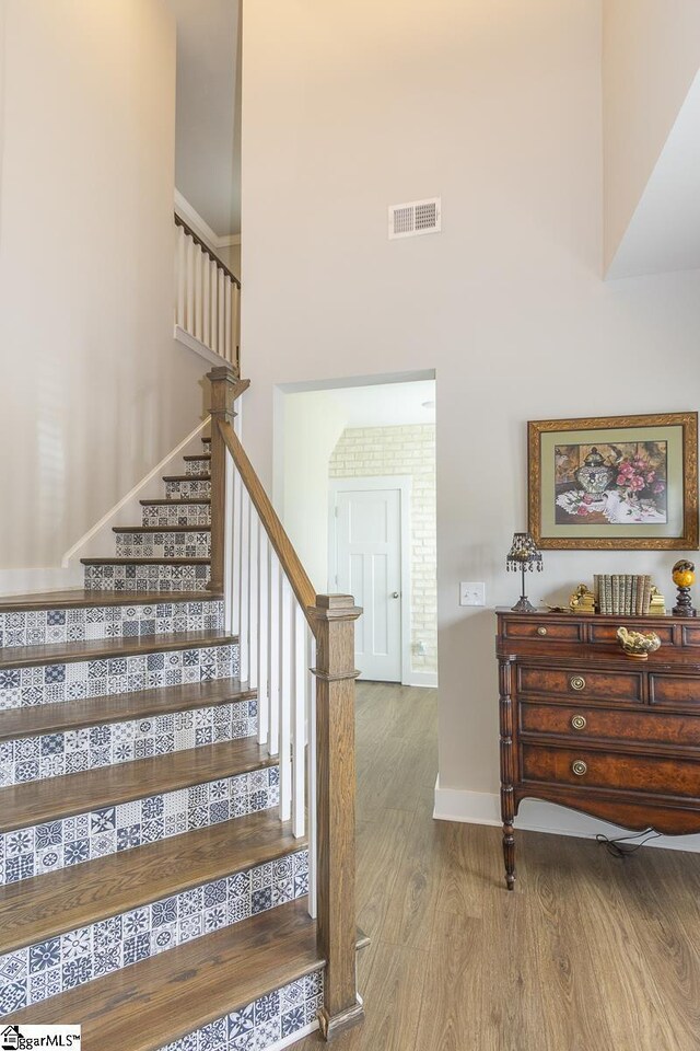 101 Greensdale Ln, Easley, SC 29642 - stairs featuring wood finished floors, a high ceiling, and baseboards