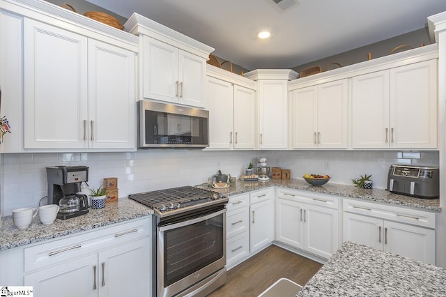101 Greensdale Ln, Easley, SC 29642 - kitchen featuring stainless steel appliances, white cabinets, dark wood-style floors, and recessed lighting